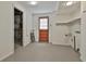 Functional basement space with an exterior door, shelving, and plumbing, offering potential for various uses at 2941 Pine Valley Cir, East Point, GA 30344