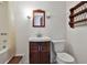 Charming bathroom featuring a vanity, toilet, and a shower with a curtain, complemented by a wooden shelf at 2941 Pine Valley Cir, East Point, GA 30344