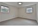 Simple bedroom with neutral walls, hardwood floors, and natural light from two windows creating a calm atmosphere at 2941 Pine Valley Cir, East Point, GA 30344