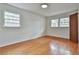 Bright bedroom with hardwood floors, two windows, and fresh, neutral paint creating a serene and inviting space at 2941 Pine Valley Cir, East Point, GA 30344