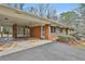 View of a screened porch with a car port and a brick exterior home with blue shutters at 2941 Pine Valley Cir, East Point, GA 30344