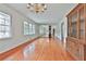 Spacious living room with hardwood floors, large windows, and a vintage chandelier at 2941 Pine Valley Cir, East Point, GA 30344