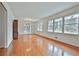 Open living room with hardwood floors, white walls, large windows, and chandelier at 2941 Pine Valley Cir, East Point, GA 30344