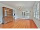 Living room showcasing hardwood floors, white walls, glass doors, and a vintage china cabinet at 2941 Pine Valley Cir, East Point, GA 30344