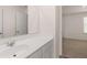 Bathroom with a white countertop, single sink, and a view into the bedroom at 310 Aspen Valley Dr, Loganville, GA 30052