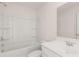 An all-white bathroom features a tub and a sink with vanity at 310 Aspen Valley Dr, Loganville, GA 30052