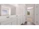 Bathroom with dual sinks, white cabinets and a view to the bedroom at 310 Aspen Valley Dr, Loganville, GA 30052