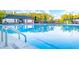 Community swimming pool with clear blue water and ladder, with a view of the clubhouse at 310 Aspen Valley Dr, Loganville, GA 30052