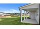 A covered patio sits off of the green backyard and features white columns at 310 Aspen Valley Dr, Loganville, GA 30052