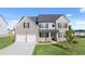 Charming two-story home featuring a two-car garage, brick accents, and a well-manicured lawn at 310 Aspen Valley Dr, Loganville, GA 30052