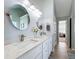 Bright bathroom with double sinks, oval mirrors, white cabinetry, and quartz countertops at 530 Firethorn Ct, Villa Rica, GA 30180