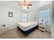 Neutral bedroom with two windows, a ceiling fan, and simple furnishings at 530 Firethorn Ct, Villa Rica, GA 30180