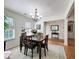 Bright dining room features a chandelier, hardwood floors, area rug and adjacent butler's pantry at 530 Firethorn Ct, Villa Rica, GA 30180