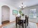 Dining room with wood table and chairs, chandelier, area rug, and lots of light at 530 Firethorn Ct, Villa Rica, GA 30180