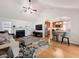 Living room with fireplace, view of kitchen bar, ceiling fan, and hardwood floors at 530 Firethorn Ct, Villa Rica, GA 30180