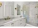 Elegant bathroom with marble counters, dual sinks, gold accents, and walk-in shower with marble tile surround at 96 Sheridan Dr, Atlanta, GA 30305