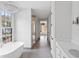 Modern bathroom featuring a freestanding tub, chandelier, and walk-in shower with glass enclosure at 96 Sheridan Dr, Atlanta, GA 30305