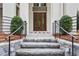 Inviting front entrance with stone steps, wrought iron railing, and beautifully crafted wooden double doors at 96 Sheridan Dr, Atlanta, GA 30305