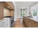 Bright kitchen with stainless steel appliances, marble countertops, and sleek wooden cabinetry at 96 Sheridan Dr, Atlanta, GA 30305