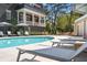 Community pool with several lounge chairs, tables and umbrellas, and adjacent residential building at 96 Sheridan Dr, Atlanta, GA 30305