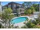 Community pool with lounge chairs and umbrellas with residential building in background at 96 Sheridan Dr, Atlanta, GA 30305