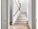 Elegant staircase with wood treads, white risers, and a curved wood handrail at 96 Sheridan Dr, Atlanta, GA 30305