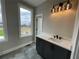 Modern bathroom with a sleek vanity, black fixtures, and a large window with natural light at 968 Bibbs Circle Nw, Atlanta, GA 30318