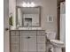 Well-lit bathroom with a gray vanity, large mirror, and a combination shower and tub with a shower curtain at 3220 Celebration Blvd, Suwanee, GA 30024