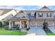 Charming exterior view of a home with stone and siding, well-manicured lawn, and a welcoming entrance at 3220 Celebration Blvd, Suwanee, GA 30024