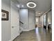 Well-lit hallway featuring hardwood floors, modern lighting, and access to various rooms in the home at 3220 Celebration Blvd, Suwanee, GA 30024