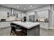 Modern kitchen with a large center island, white cabinetry, stainless steel appliances, and hardwood floors at 3220 Celebration Blvd, Suwanee, GA 30024