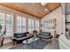 Open living room with wood ceiling, skylight, large windows with shutters, hardwood floors, and modern furniture at 3220 Celebration Blvd, Suwanee, GA 30024