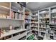 Walk-in pantry with custom shelving, providing ample storage for kitchen supplies and small appliances at 3220 Celebration Blvd, Suwanee, GA 30024