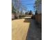 Spacious backyard featuring newly installed sod, a secure black metal fence, and a concrete walkway at 2111 Lilly Nw Way, Atlanta, GA 30318