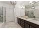 The bathroom is complete with marble floors, a double vanity, and a large, glass-enclosed shower at 2111 Lilly Nw Way, Atlanta, GA 30318