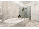 Spa-like bathroom features marble floors, a standalone tub, and a glass-enclosed shower at 2111 Lilly Nw Way, Atlanta, GA 30318