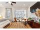 Bedroom featuring a sitting area, flat-screen TV and bright light at 2111 Lilly Nw Way, Atlanta, GA 30318