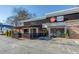 Restaurant exterior featuring outdoor patio and dining, stone facade, and ample parking at 2111 Lilly Nw Way, Atlanta, GA 30318