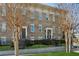 Charming brick townhome featuring a wrought iron fence and well manicured front lawn at 2111 Lilly Nw Way, Atlanta, GA 30318