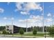 Modern golf facility with multiple driving ranges, set against a backdrop of lush greenery and a clear blue sky at 2111 Lilly Nw Way, Atlanta, GA 30318