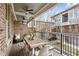 Cozy covered patio featuring a wooden dining table and a brick accent wall overlooking the neighborhood at 2111 Lilly Nw Way, Atlanta, GA 30318