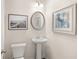 Stylish powder room featuring pedestal sink, framed art, and modern fixtures at 225 Epping St # 92, Stockbridge, GA 30281