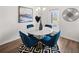 Dining room featuring a round table with blue chairs, a black and white rug, and modern lighting at 225 Epping St # 92, Stockbridge, GA 30281