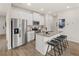 Modern kitchen featuring stainless steel appliances, an island with granite counters, and three stools at 225 Epping St # 92, Stockbridge, GA 30281