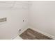 Unfinished laundry room with wood look flooring, shelf, and washer/dryer hookups at 225 Epping St # 92, Stockbridge, GA 30281