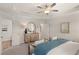 Bright bedroom featuring a tray ceiling, wood floors, and a wooden dresser at 225 Epping St # 92, Stockbridge, GA 30281