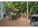 Outdoor deck with a dining table, chairs, grill and backyard views at 305 Brassy Ct, Alpharetta, GA 30022