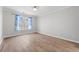 Bright bedroom features wood floors, a large window for natural light, and neutral walls at 305 Brassy Ct, Alpharetta, GA 30022