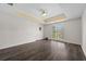 Spacious bedroom with a large window and wood-look flooring and a tray ceiling at 305 Brassy Ct, Alpharetta, GA 30022