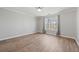 Bedroom featuring hardwood floors, large window and light gray walls at 305 Brassy Ct, Alpharetta, GA 30022